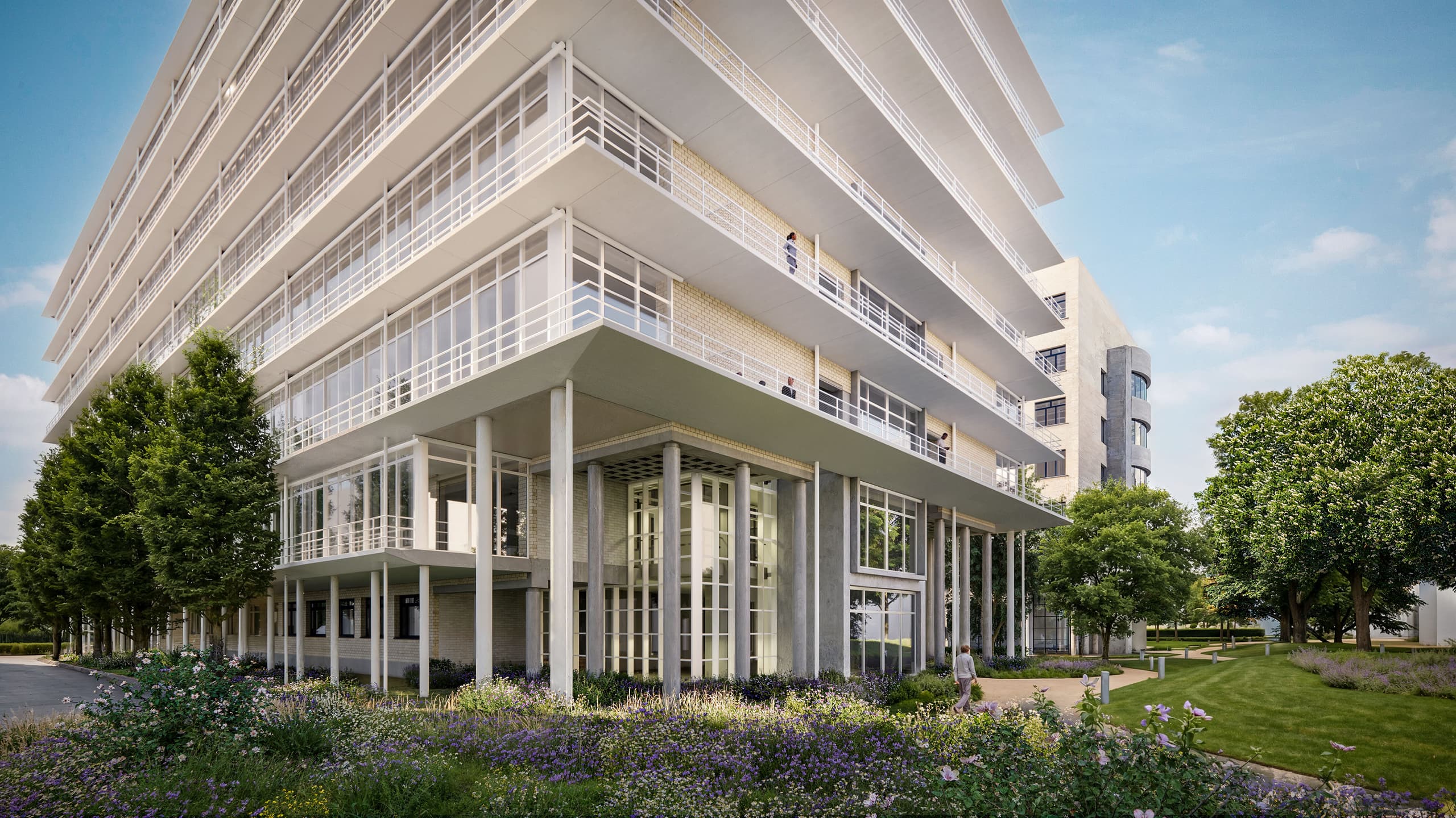 FLOW Aussenansicht – weisse Säulenfassade mit auskragenden Geschossen und blühender Parkanlage am Klybeck-Areal